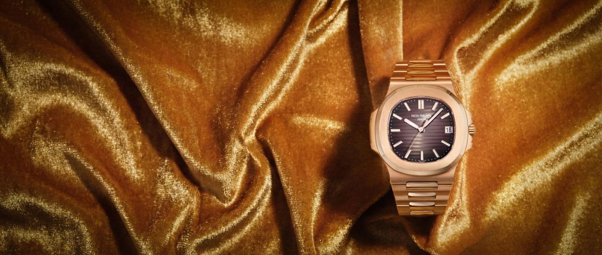 Patek Philippe luxury watch on golden fabric